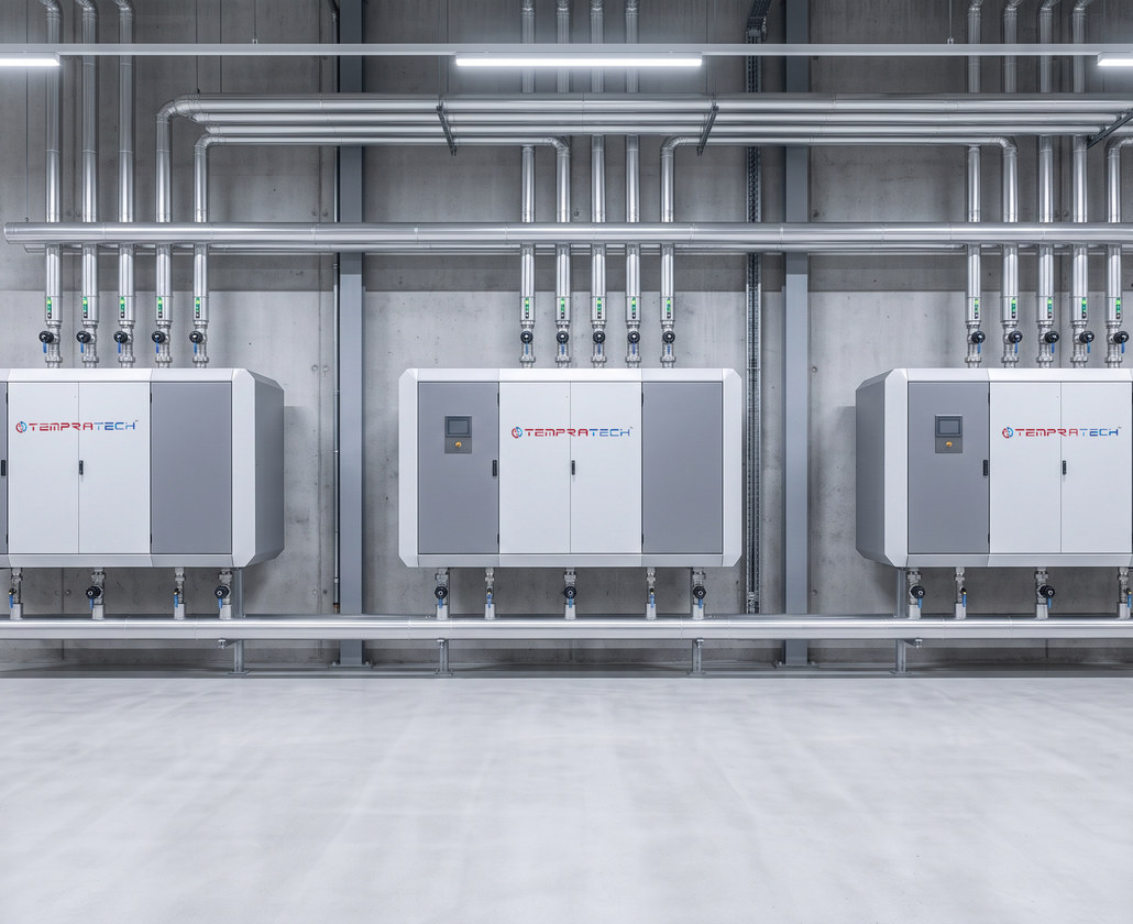 Three wall-mounted Tempratech units in a plant room, each tied into a common flow and return header